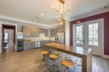 A kitchen with a bar stool and a counter at Foxwood Apartments, Raleigh-Durham, North Carolina